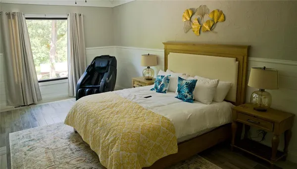 a bedroom with a bed and wooden floor