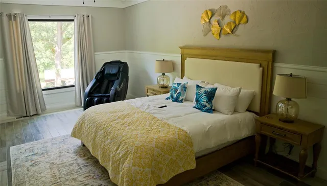 a bedroom with a bed and wooden floor