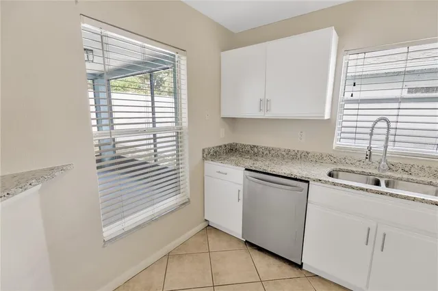 a view of a kitchen with granite countertop cabinets and a wooden floor