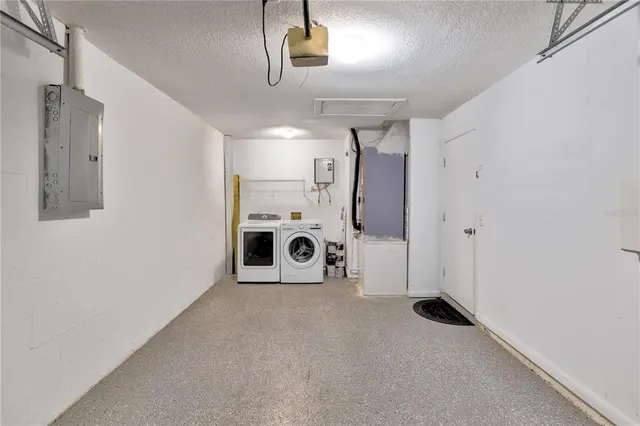 a view of a house with a yard and potted plants