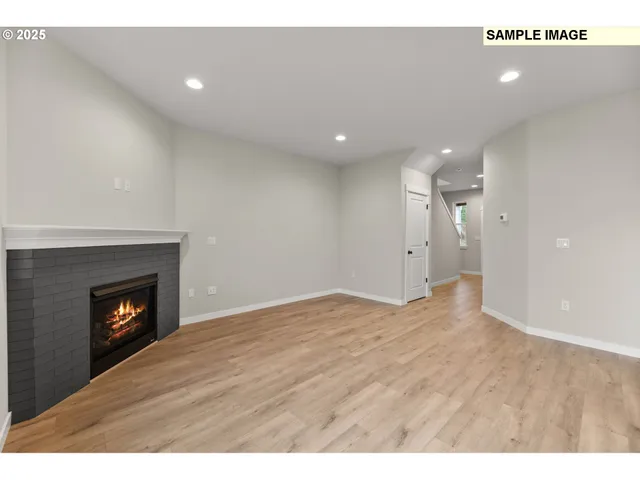 a view of an empty room with a fireplace