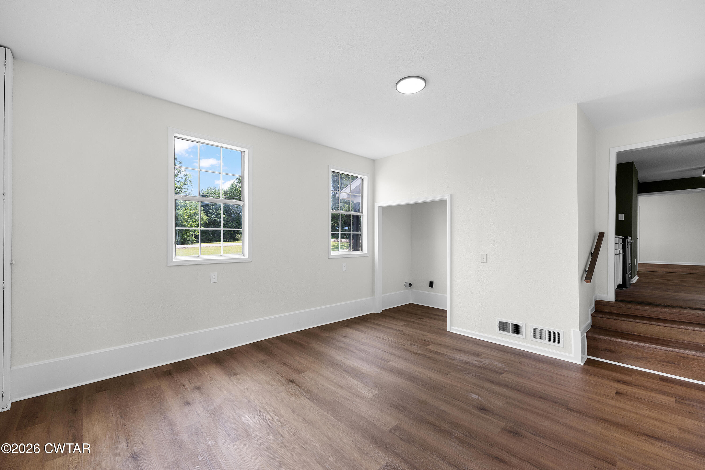 3075 Old Huntingdon Road Lexington, TN 38351 - Photo 16 of 19 a view of an empty room with wooden floor and a window