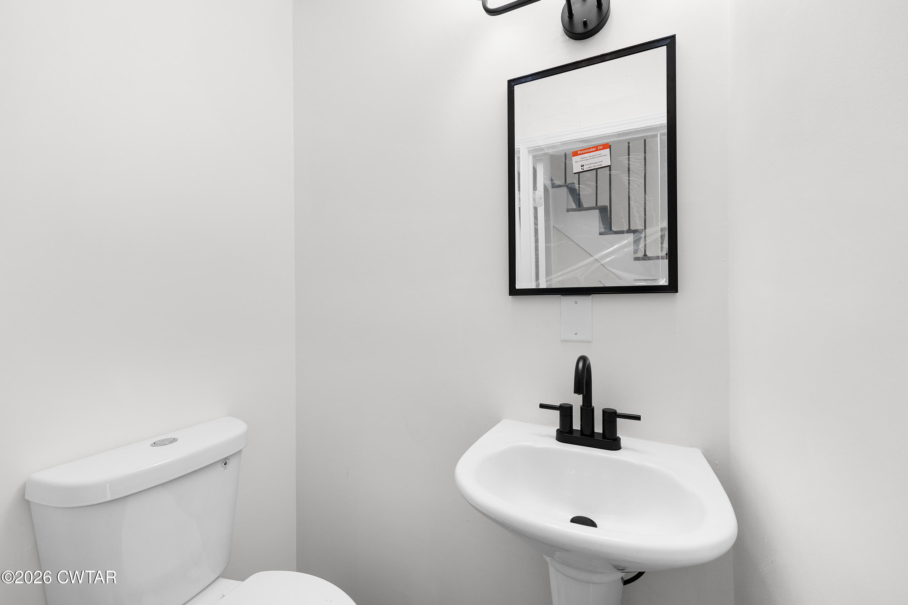 3075 Old Huntingdon Road Lexington, TN 38351 - Photo 7 of 19 a bathroom with a toilet sink and mirror