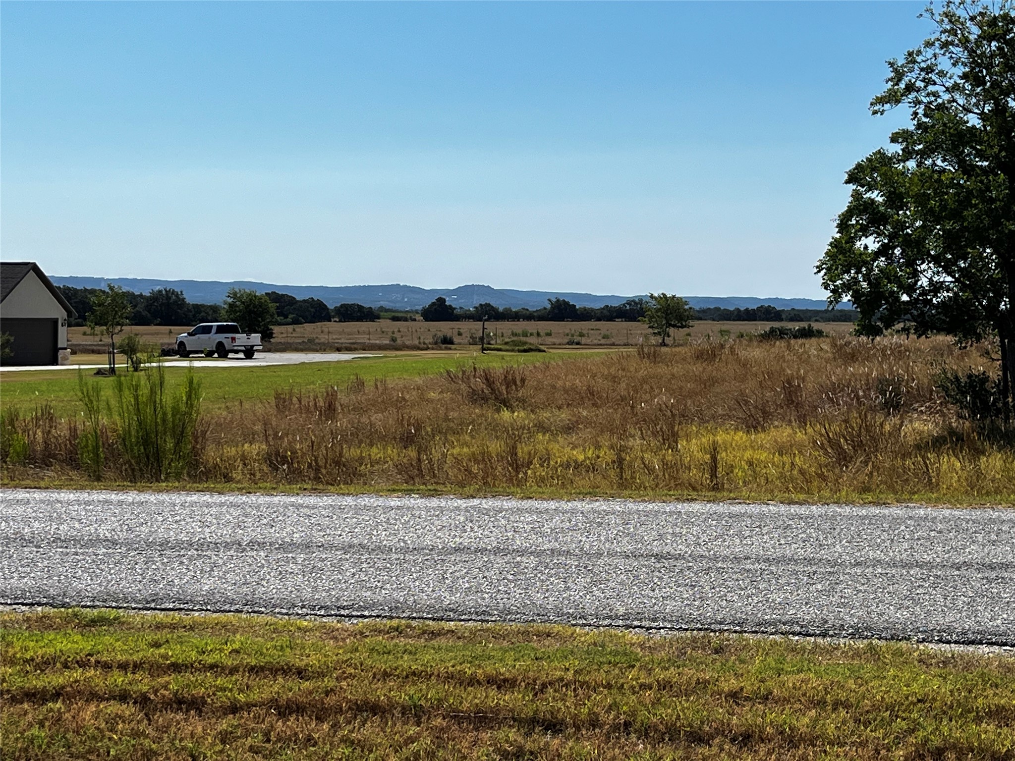 679 Palomino Springs Bandera, TX 78003 - Photo 4 of 13 a view of a lake with a yard and large trees