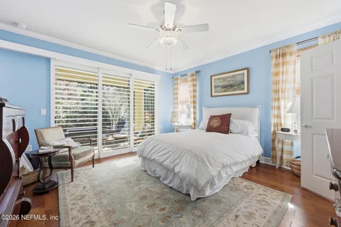 a bedroom with a bed a couch and a window