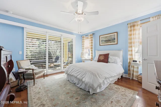 a bedroom with a bed a couch and a window