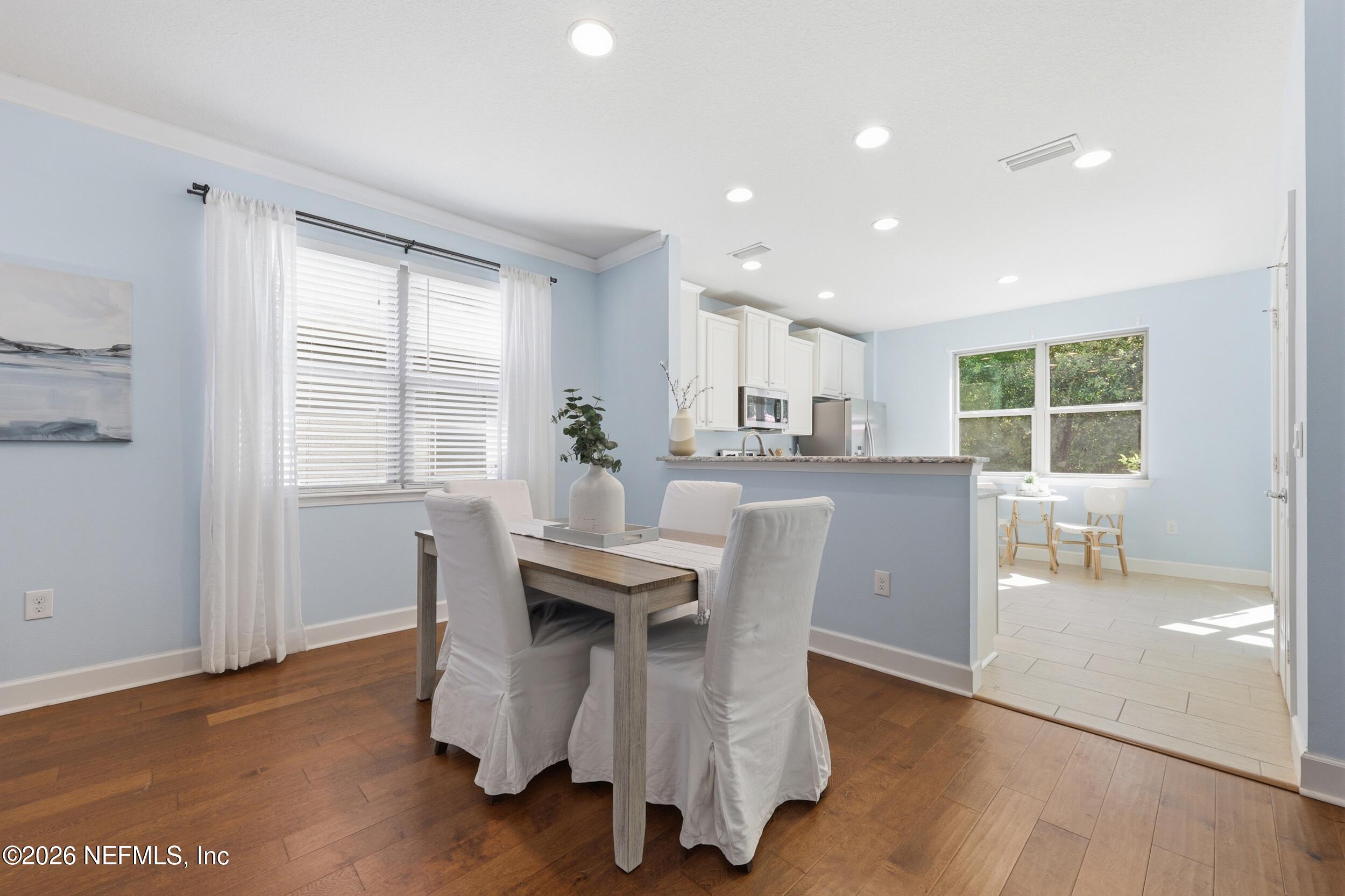 248 Hawks Harbor Road Ponte Vedra, FL 32081 - Photo 16 of 60 a dining room with furniture and wooden floor