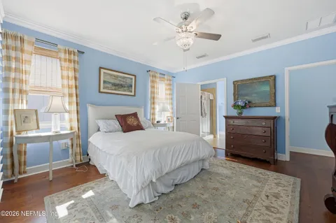 a bedroom with a bed a dresser and a window