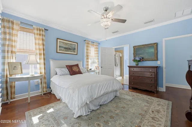 a bedroom with a bed a dresser and a window