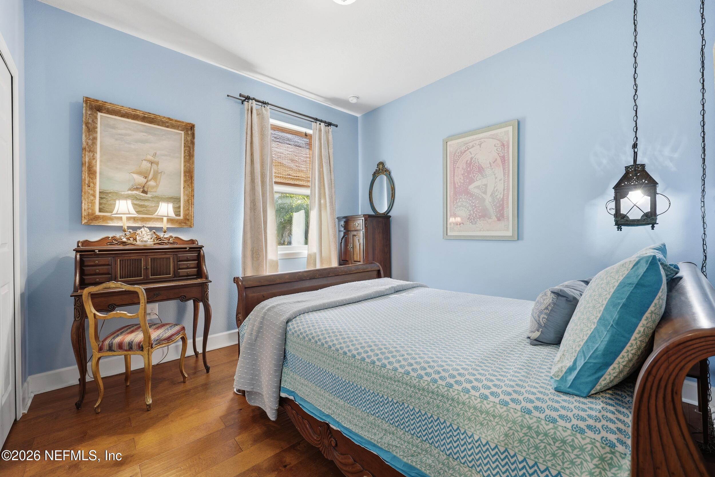 248 Hawks Harbor Road Ponte Vedra, FL 32081 - Photo 18 of 52 a bedroom with a bed a chandelier and a window