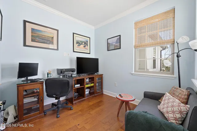 a livingroom with workspace and a window