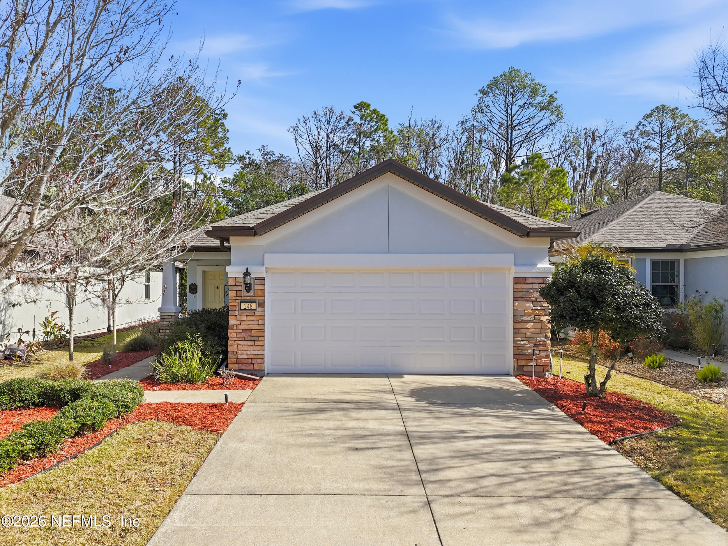 248 Hawks Harbor Road Ponte Vedra, FL 32081 - Photo 3 of 52 a front view of a house with a yard and potted plants