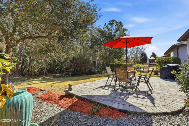 a view of a swimming pool with a table and chairs