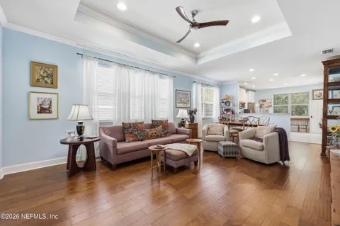a living room with furniture and wooden floor