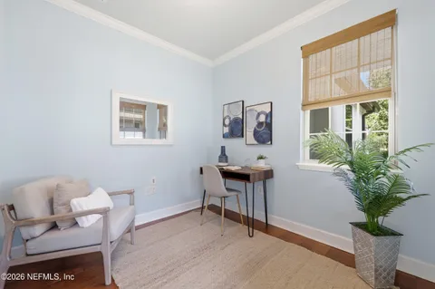 a view of swimming pool with outdoor seating and trees in the background