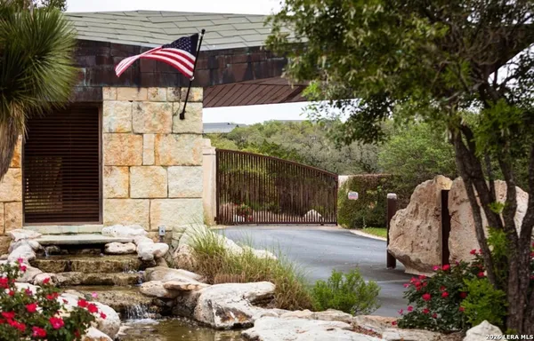 a view of backyard with a table and chairs and potted plants