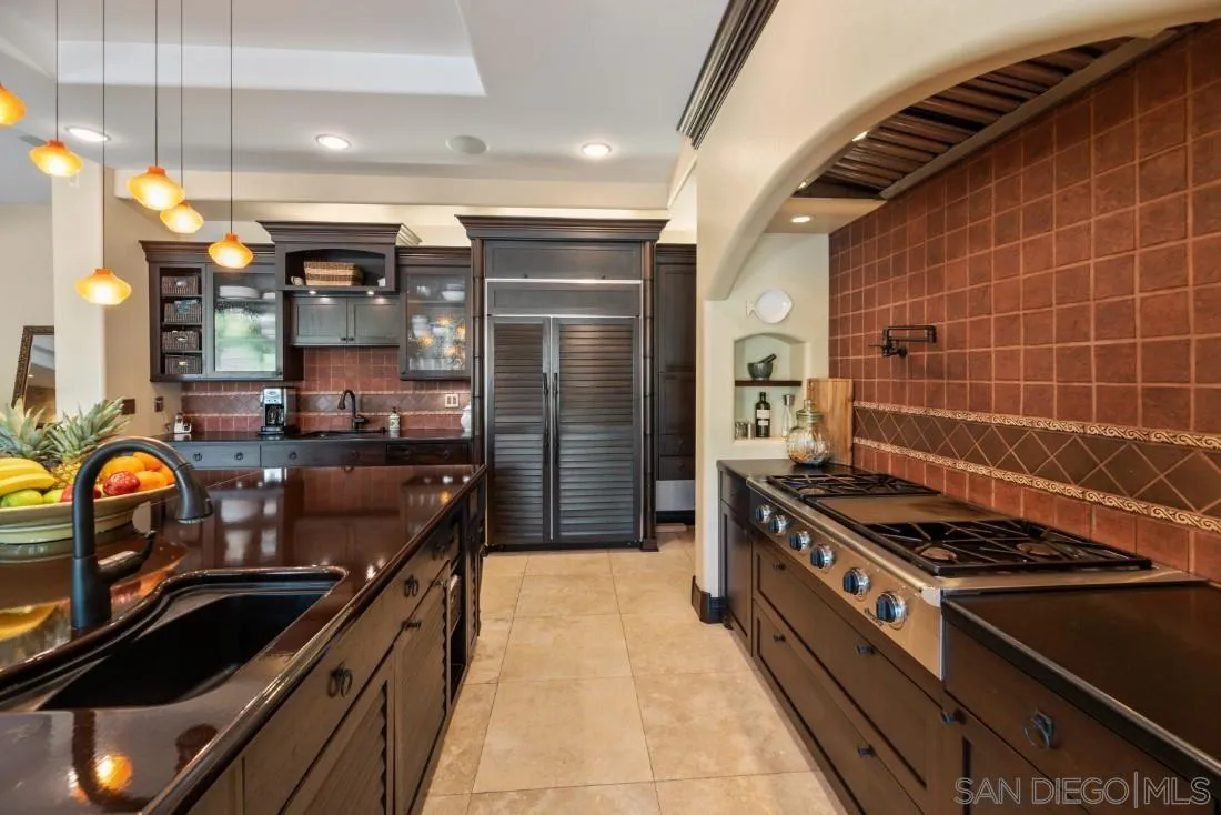 13862 Deergrass Court Poway, CA 92064 - Photo 12 of 51 a kitchen with granite countertop a stove and a refrigerator