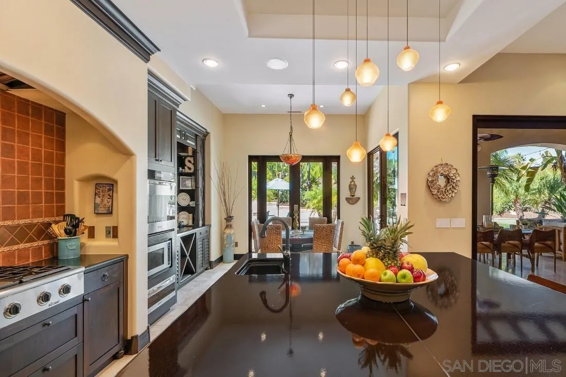 13862 Deergrass Court Poway, CA 92064 - Photo 14 of 51 a room with stainless steel appliances lots of wooden furniture dining table and chairs
