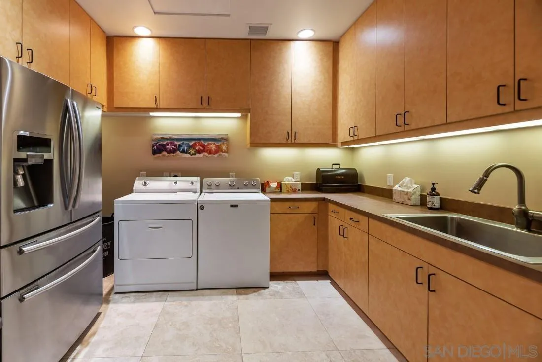 13862 Deergrass Court Poway, CA 92064 - Photo 20 of 51 a kitchen with a sink cabinets and stainless steel appliances
