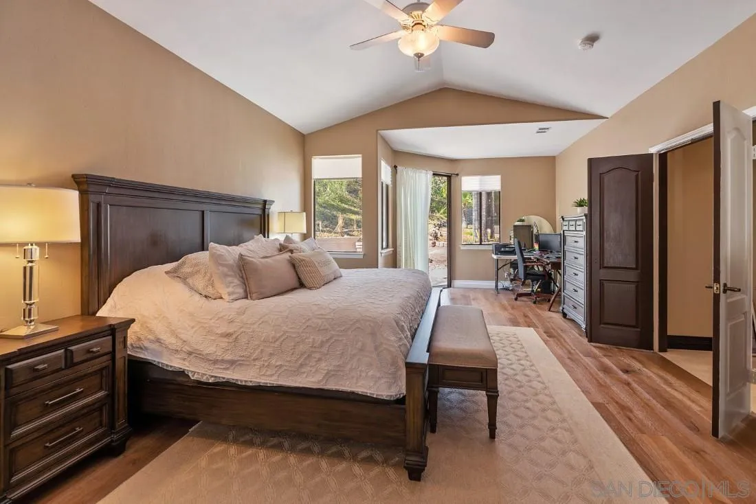13862 Deergrass Court Poway, CA 92064 - Photo 22 of 51 a bed room with a bed and a chandelier