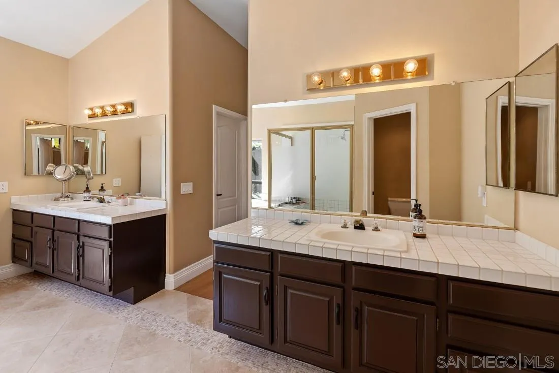 13862 Deergrass Court Poway, CA 92064 - Photo 25 of 51 a bathroom with a double vanity sink mirror and double