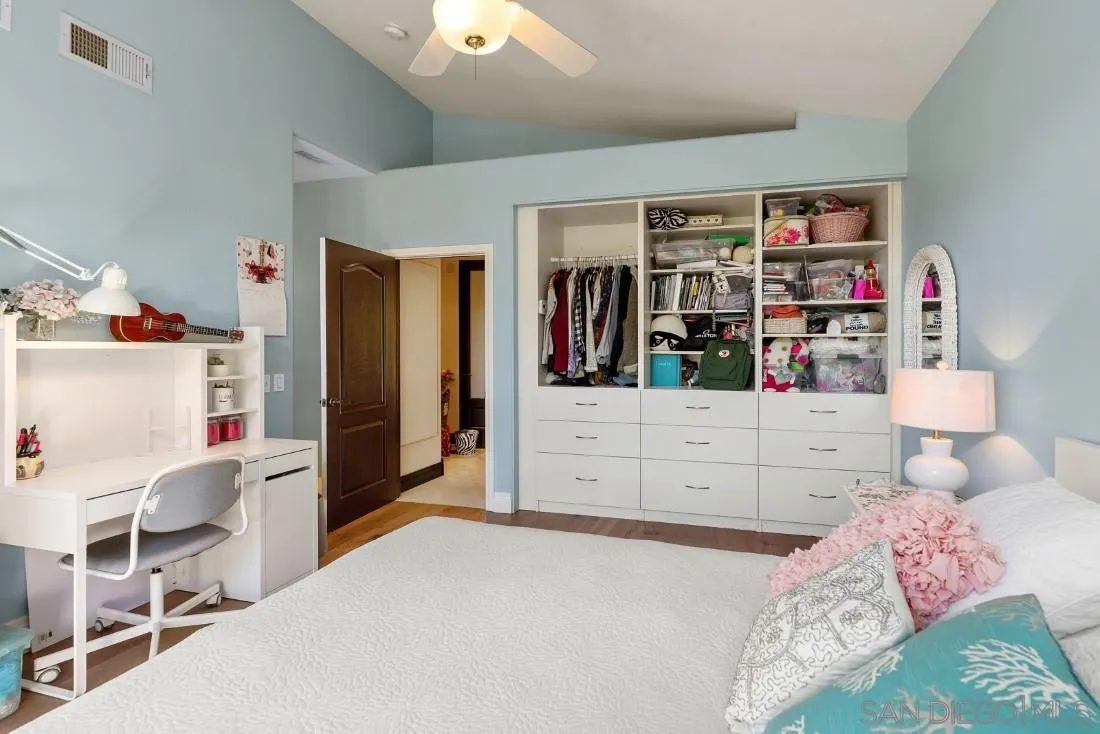 13862 Deergrass Court Poway, CA 92064 - Photo 34 of 51 a bedroom with a bed closet and flat screen tv