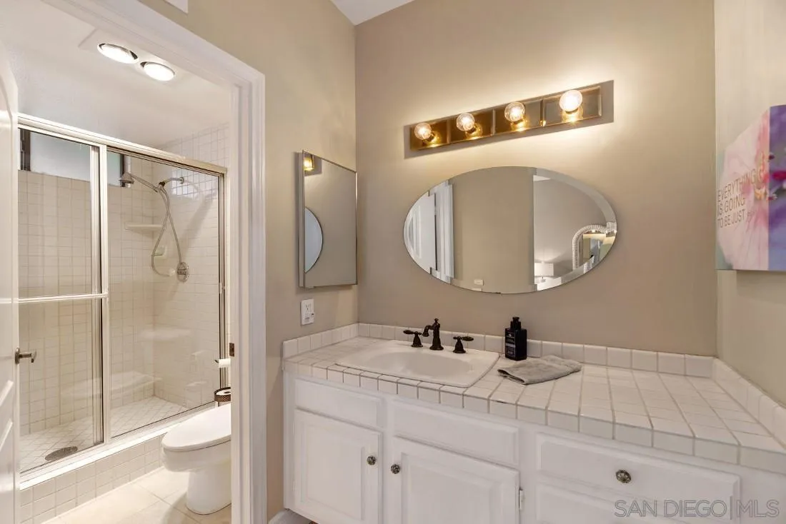 13862 Deergrass Court Poway, CA 92064 - Photo 35 of 51 a bathroom with a sink a toilet and shower