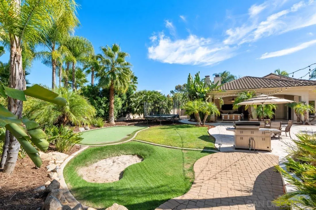 13862 Deergrass Court Poway, CA 92064 - Photo 46 of 51 a view of a swimming pool with lawn chairs under an umbrella