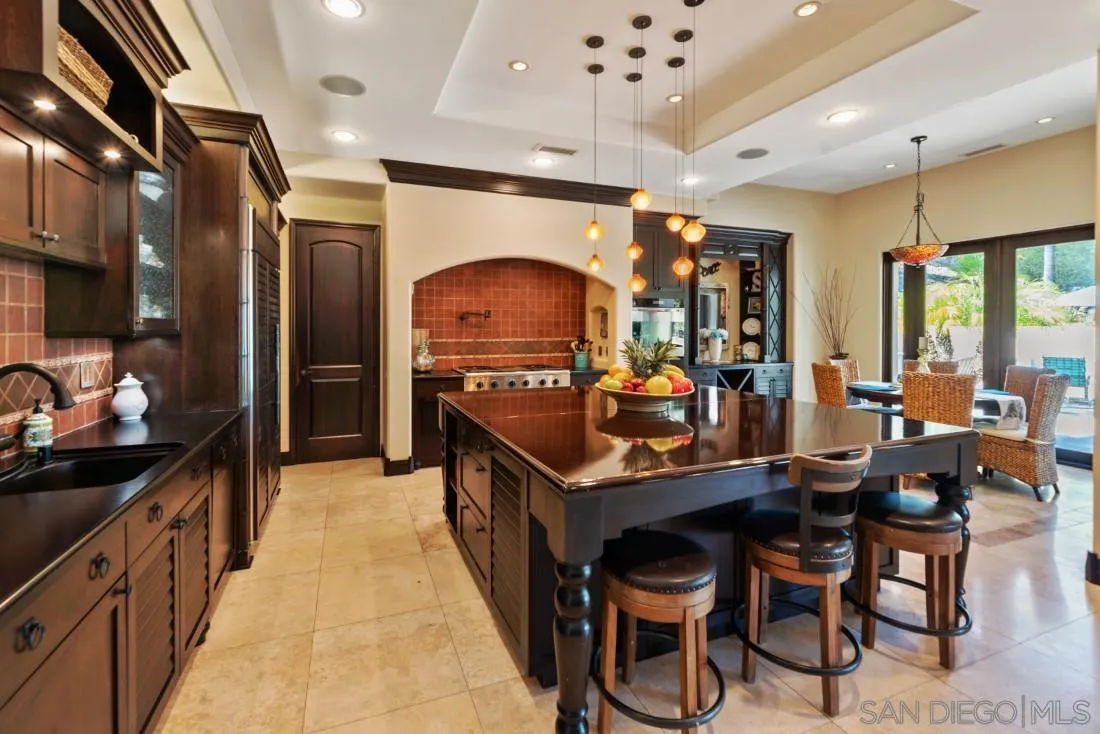 13862 Deergrass Court Poway, CA 92064 - Photo 9 of 51 a kitchen with granite countertop a stove a sink and a refrigerator