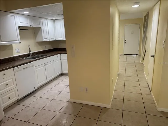 a spacious bathroom with a granite countertop sink a mirror and a shower