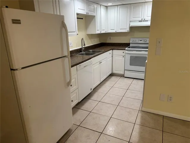 a white refrigerator freezer sitting inside of a kitchen