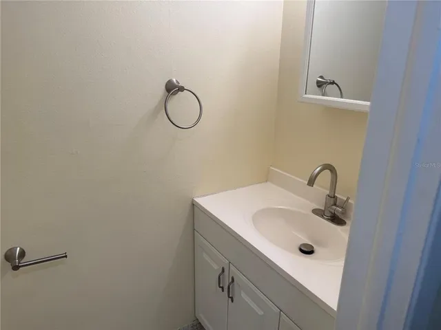 a bathroom with a sink and mirror