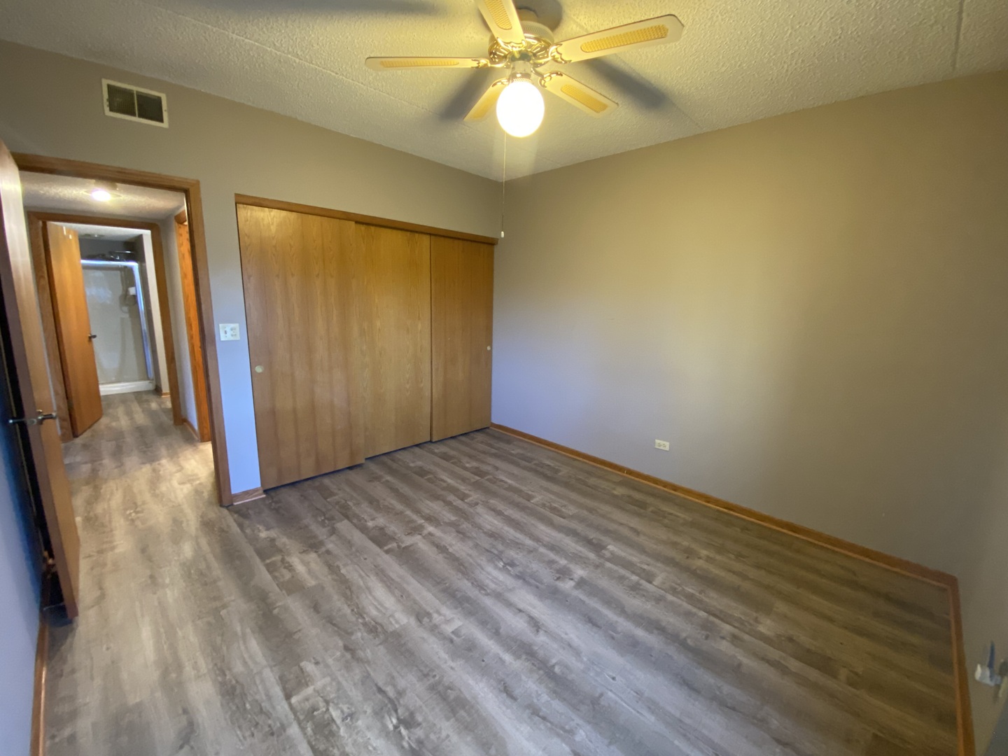 1105 East Division Street, Unit 1B Lockport, IL 60441 - Photo 14 of 22 wooden floor in an empty room with a window