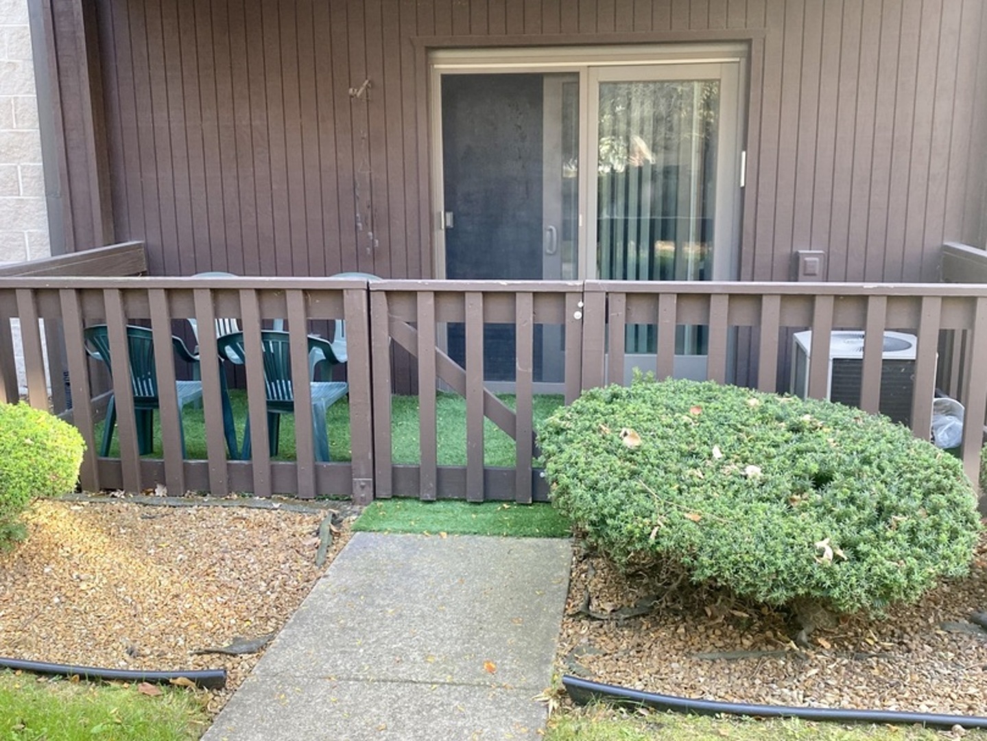 1105 East Division Street, Unit 1B Lockport, IL 60441 - Photo 3 of 22 a view of a house with a small yard and wooden fence
