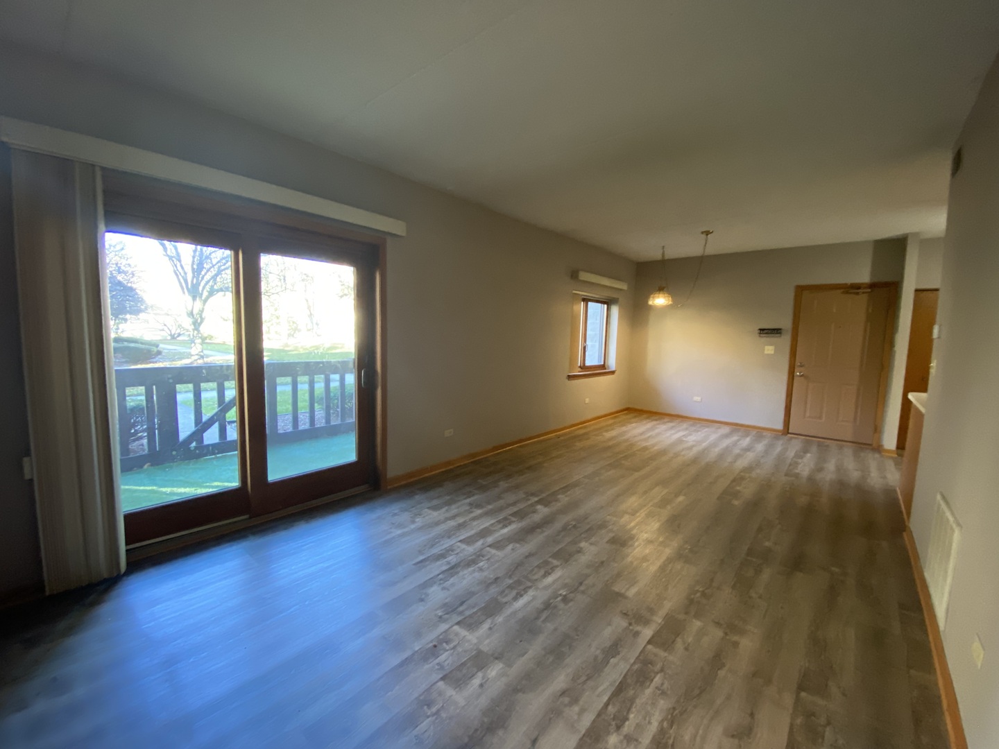 1105 East Division Street, Unit 1B Lockport, IL 60441 - Photo 9 of 22 a view of empty room with wooden floor and fan