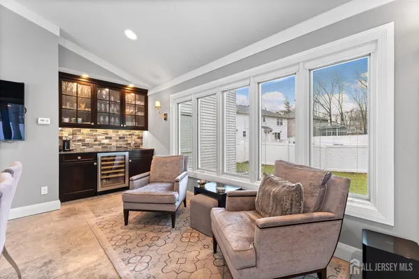 a living room with furniture and large windows
