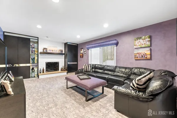 a living room with furniture fireplace and a window