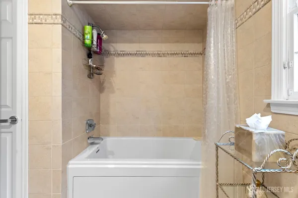 a bedroom with furniture and a flat screen tv