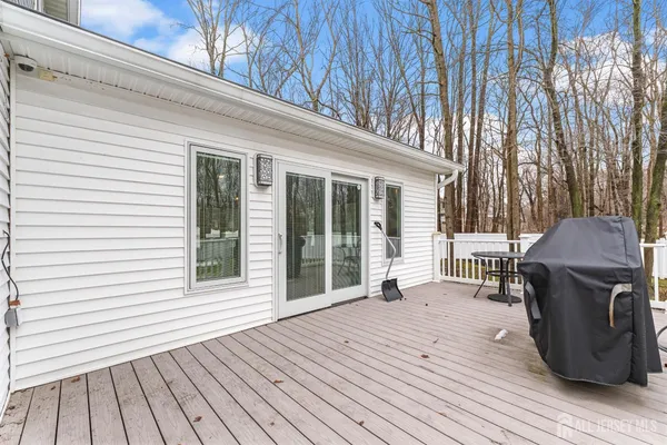 a view of a house with a big yard and large trees