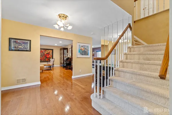 a view of entryway and hall with wooden floor