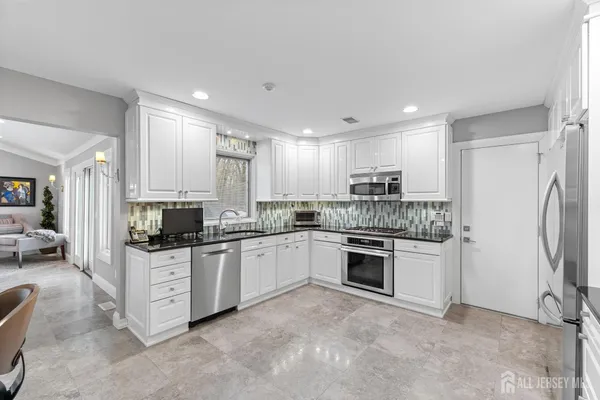 a kitchen with a sink stove and refrigerator