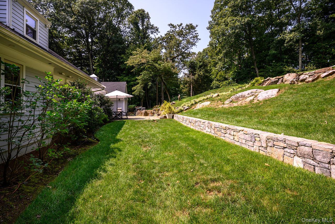 36 Pond Hill Road Chappaqua, NY 10514 - Photo 30 of 32 a view of a backyard with large trees