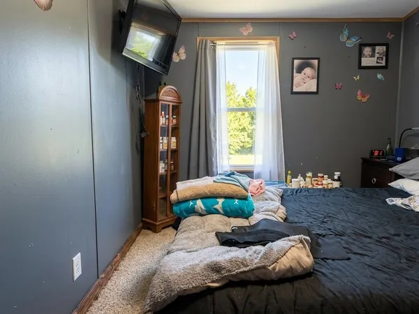 a bedroom with a bed and a window
