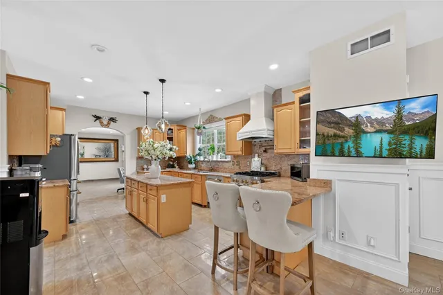 a kitchen with stainless steel appliances granite countertop a stove top oven a sink a counter top space and cabinets