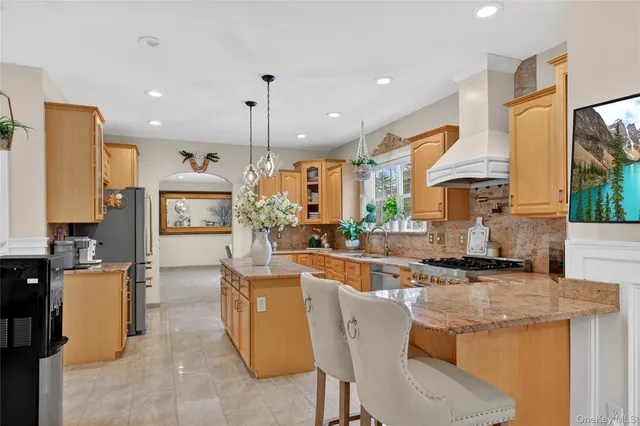 a kitchen with stainless steel appliances kitchen island granite countertop a sink and cabinets