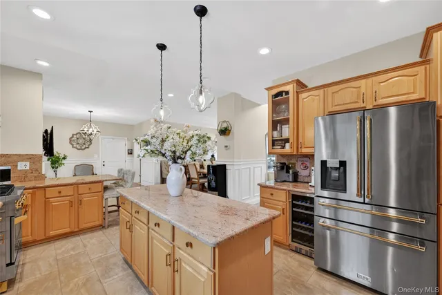 a kitchen with stainless steel appliances granite countertop a sink a stove and a refrigerator