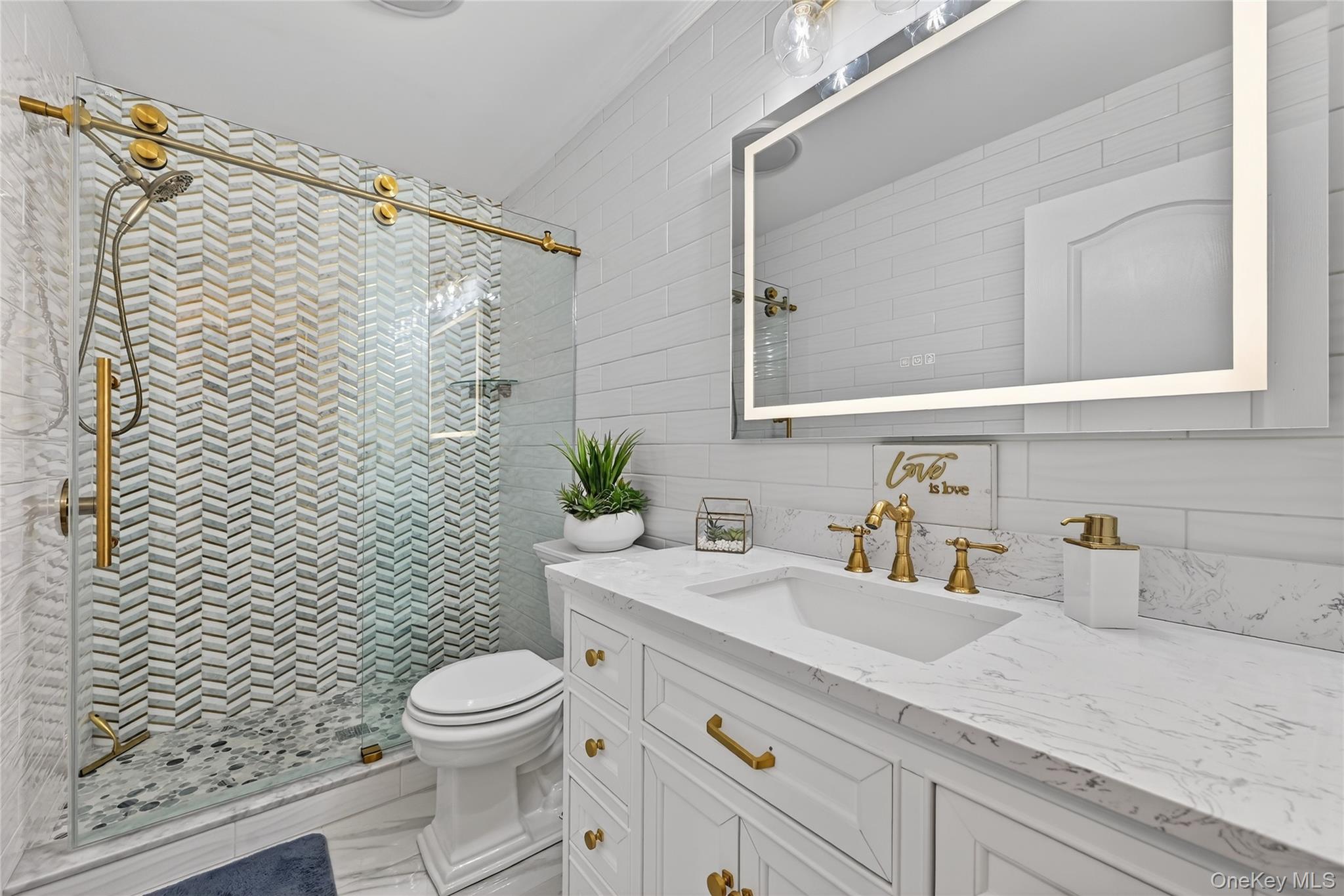16 Kukas Road Monticello, NY 12701 - Photo 40 of 50 a bathroom with a granite countertop toilet a sink and a mirror
