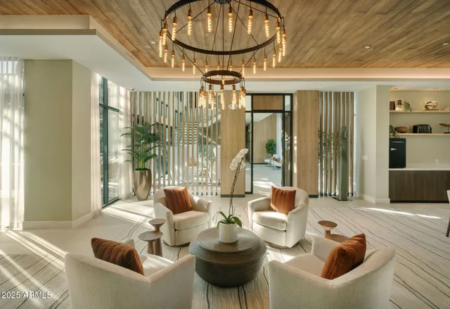 a living room with furniture and a floor to ceiling window