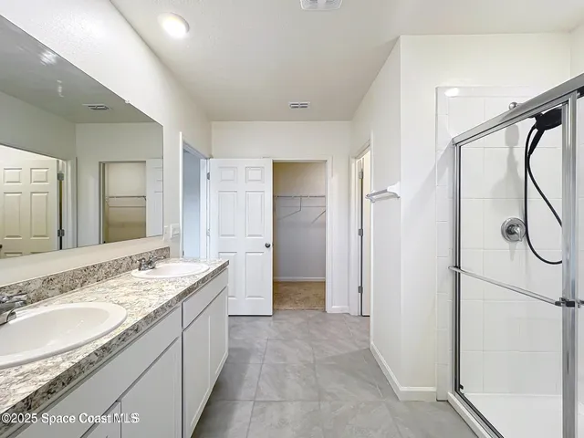 a spacious bathroom with a granite countertop sink mirror and double