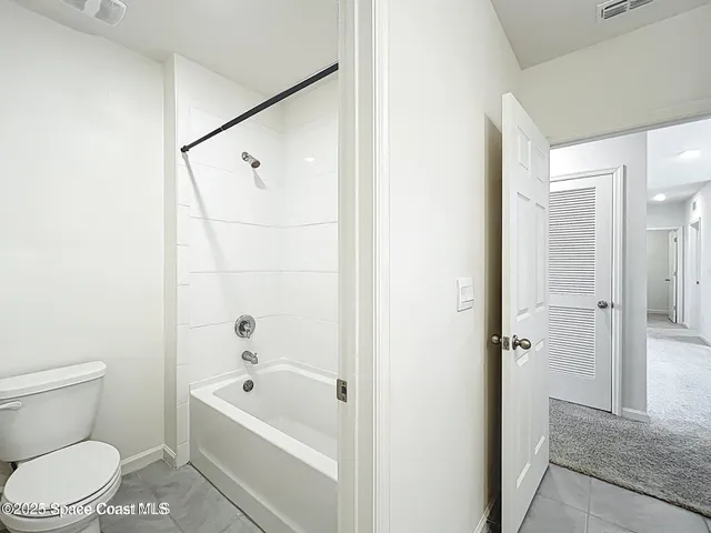 a bathroom with a toilet and a bathtub